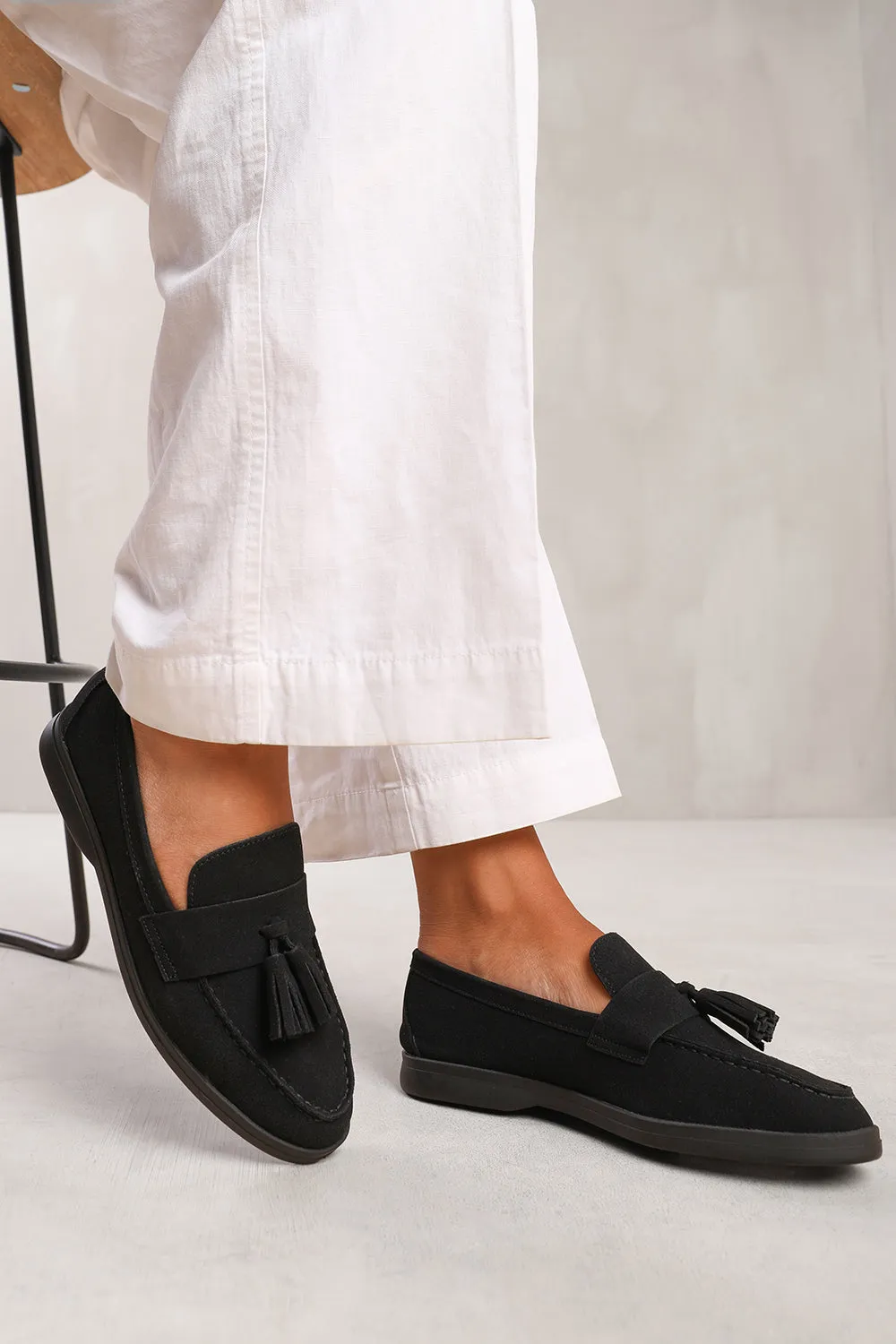 KENYA SLIP ON LOAFER WITH TASSEL DETAILING IN BLACK SUEDE